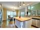 Well-designed kitchen with a butcher block island, stainless steel appliances, and an open view of the dining room at 1615 Mount Mckinley Dr, Grayson, GA 30017
