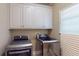Laundry room featuring a washer and dryer, and overhead cabinets for ample storage at 1615 Mount Mckinley Dr, Grayson, GA 30017