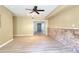 Spacious room with hardwood floors, ceiling fan, recessed lights, and stone accent wall at 1615 Mount Mckinley Dr, Grayson, GA 30017
