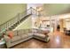 Open-concept living room showcasing a staircase, high ceilings, and an adjoining kitchen and dining area at 1615 Mount Mckinley Dr, Grayson, GA 30017