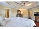 Spacious main bedroom with tray ceilings, ensuite bath access, wood floors, and a ceiling fan at 1615 Mount Mckinley Dr, Grayson, GA 30017