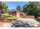 View of the back of the house with a wooden fence, patio, and driveway at 1661 Barrett Nw Dr, Atlanta, GA 30318