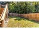 A large, green backyard featuring a wood fence is perfect for children to play and dogs to run at 1661 Barrett Nw Dr, Atlanta, GA 30318