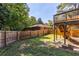 Fenced backyard includes a deck, a lush lawn, and plenty of shade trees, providing a private outdoor oasis at 1661 Barrett Nw Dr, Atlanta, GA 30318