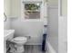 Bright bathroom featuring white tiled walls, sink, toilet, and shower/tub combination at 1661 Barrett Nw Dr, Atlanta, GA 30318