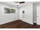 A bedroom features hardwood flooring, a ceiling fan, and natural light from the window at 1661 Barrett Nw Dr, Atlanta, GA 30318