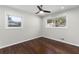 An empty bedroom boasting wood flooring, gray walls, two windows, and a ceiling fan at 1661 Barrett Nw Dr, Atlanta, GA 30318