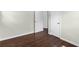 This bedroom features hardwood floors, neutral walls and trim, and two closets at 1661 Barrett Nw Dr, Atlanta, GA 30318