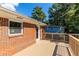 A beautiful wood deck with brick siding is perfect for outdoor relaxation and entertaining at 1661 Barrett Nw Dr, Atlanta, GA 30318