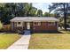 Charming single-story brick home featuring a well-manicured front lawn and inviting curb appeal at 1661 Barrett Nw Dr, Atlanta, GA 30318