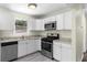 Kitchen featuring stainless steel appliances, white cabinetry, and stone countertops at 1661 Barrett Nw Dr, Atlanta, GA 30318