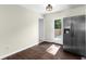 Kitchen view showcasing stainless steel refrigerator, hardwood floors, and access to outdoor deck at 1661 Barrett Nw Dr, Atlanta, GA 30318