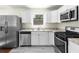 Updated kitchen showcasing stainless steel appliances and stone countertops at 1661 Barrett Nw Dr, Atlanta, GA 30318
