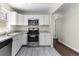 Kitchen featuring stainless steel appliances, white cabinetry, and modern countertops at 1661 Barrett Nw Dr, Atlanta, GA 30318