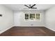 Inviting living space with hardwood floors, a ceiling fan, and a sunlit window at 1661 Barrett Nw Dr, Atlanta, GA 30318