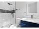 Renovated bathroom showcases modern fixtures, striking black and white accents, and a glass-enclosed shower at 353 Old Rosser Rd, Stone Mountain, GA 30087