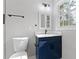 Updated bathroom featuring blue vanity, white marble countertop and a window with natural light at 353 Old Rosser Rd, Stone Mountain, GA 30087