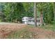 Charming home with a white picket fence and a bright blue front door nestled among lush greenery at 353 Old Rosser Rd, Stone Mountain, GA 30087