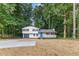 Charming home with well-manicured lawn, new concrete driveway and inviting front porch at 353 Old Rosser Rd, Stone Mountain, GA 30087