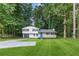 Charming home with well-manicured lawn, new concrete driveway and inviting front porch at 353 Old Rosser Rd, Stone Mountain, GA 30087
