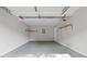 Spacious garage with painted walls, shelving and epoxy flooring offers ample storage at 353 Old Rosser Rd, Stone Mountain, GA 30087