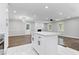 Kitchen island view featuring open floor plan with new flooring, modern lights, and updated finishes at 353 Old Rosser Rd, Stone Mountain, GA 30087
