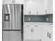 Updated kitchen featuring stainless steel appliances, white cabinets, and a subway tile backsplash at 353 Old Rosser Rd, Stone Mountain, GA 30087