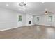 Bright and airy living room with new floors, modern lighting, brick fireplace and updated trim at 353 Old Rosser Rd, Stone Mountain, GA 30087