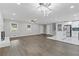 Spacious living room featuring fireplace, new floors, updated kitchen and modern ceiling light at 353 Old Rosser Rd, Stone Mountain, GA 30087