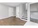 Inviting living room featuring hardwood floors, white trim, and an adjacent stairway to the basement at 353 Old Rosser Rd, Stone Mountain, GA 30087