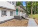 Charming home featuring a cozy covered porch with a concrete walkway, and a landscaped yard at 353 Old Rosser Rd, Stone Mountain, GA 30087
