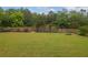 Large backyard with green grass and wooded fence line at 5130 Hopewell Manor Dr, Cumming, GA 30028