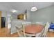 Bright dining area with hardwood floors, a wooden table set, and view of the kitchen at 5130 Hopewell Manor Dr, Cumming, GA 30028