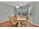 Well-lit dining room with a wooden table set, six chairs, and a large bay window at 5130 Hopewell Manor Dr, Cumming, GA 30028