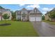 Beautiful two-story home featuring a two-car garage and a lush green lawn at 5130 Hopewell Manor Dr, Cumming, GA 30028