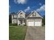 Charming two-story brick home with a two-car garage and well-manicured lawn at 5130 Hopewell Manor Dr, Cumming, GA 30028