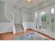 Bright foyer features hardwood floors, staircase, and front door with sidelights at 5130 Hopewell Manor Dr, Cumming, GA 30028