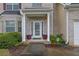 Inviting front entrance with decorative plants, a paved walkway, and a covered porch at 5130 Hopewell Manor Dr, Cumming, GA 30028