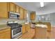 Well-equipped kitchen featuring granite countertops, stainless steel appliances, and wood cabinets at 5130 Hopewell Manor Dr, Cumming, GA 30028