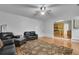Inviting living room featuring hardwood floors, comfortable seating, and seamless flow to the kitchen at 5130 Hopewell Manor Dr, Cumming, GA 30028