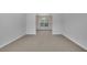 Spacious, carpeted living room with neutral walls, and an entry to dining room at 5130 Hopewell Manor Dr, Cumming, GA 30028