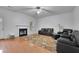 Bright living room with a fireplace, hardwood floors, and ample seating with neutral-toned decor at 5130 Hopewell Manor Dr, Cumming, GA 30028