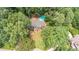 Aerial shot of the house nestled among mature trees and featuring a private pool at 5460 Lichenhearth Ct, Stone Mountain, GA 30087