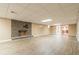 Spacious basement with a brick fireplace and modern wood-look plank flooring at 5460 Lichenhearth Ct, Stone Mountain, GA 30087