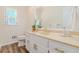 Bathroom with modern gold fixtures, white cabinets and a large framed mirror at 5460 Lichenhearth Ct, Stone Mountain, GA 30087