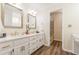 Bathroom featuring double sinks with quartz countertops and modern fixtures at 5460 Lichenhearth Ct, Stone Mountain, GA 30087