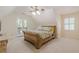 Bedroom featuring neutral carpet, a wooden bed frame and access to a balcony at 5460 Lichenhearth Ct, Stone Mountain, GA 30087