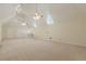 Large bonus room with neutral carpet, three ceiling fans, and a built-in bookcase at 5460 Lichenhearth Ct, Stone Mountain, GA 30087
