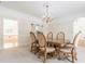 Dining room with elegant chandelier, classic dining set, and arched doorway for seamless flow at 5460 Lichenhearth Ct, Stone Mountain, GA 30087