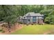 Well-manicured lawn leading up to a beautiful Tudor-style house at 5460 Lichenhearth Ct, Stone Mountain, GA 30087
